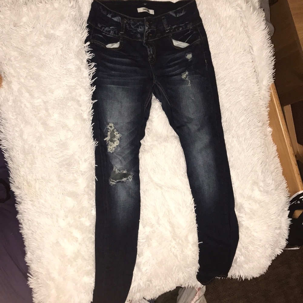 Dark distressed ripped jeans